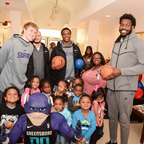 Community recognition ceremony group photo with the Greensboro Swarm at an elementary school.