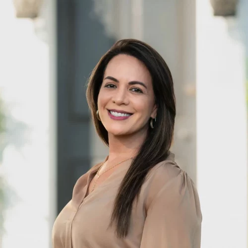 Professional headshot of smiling woman for business profile.