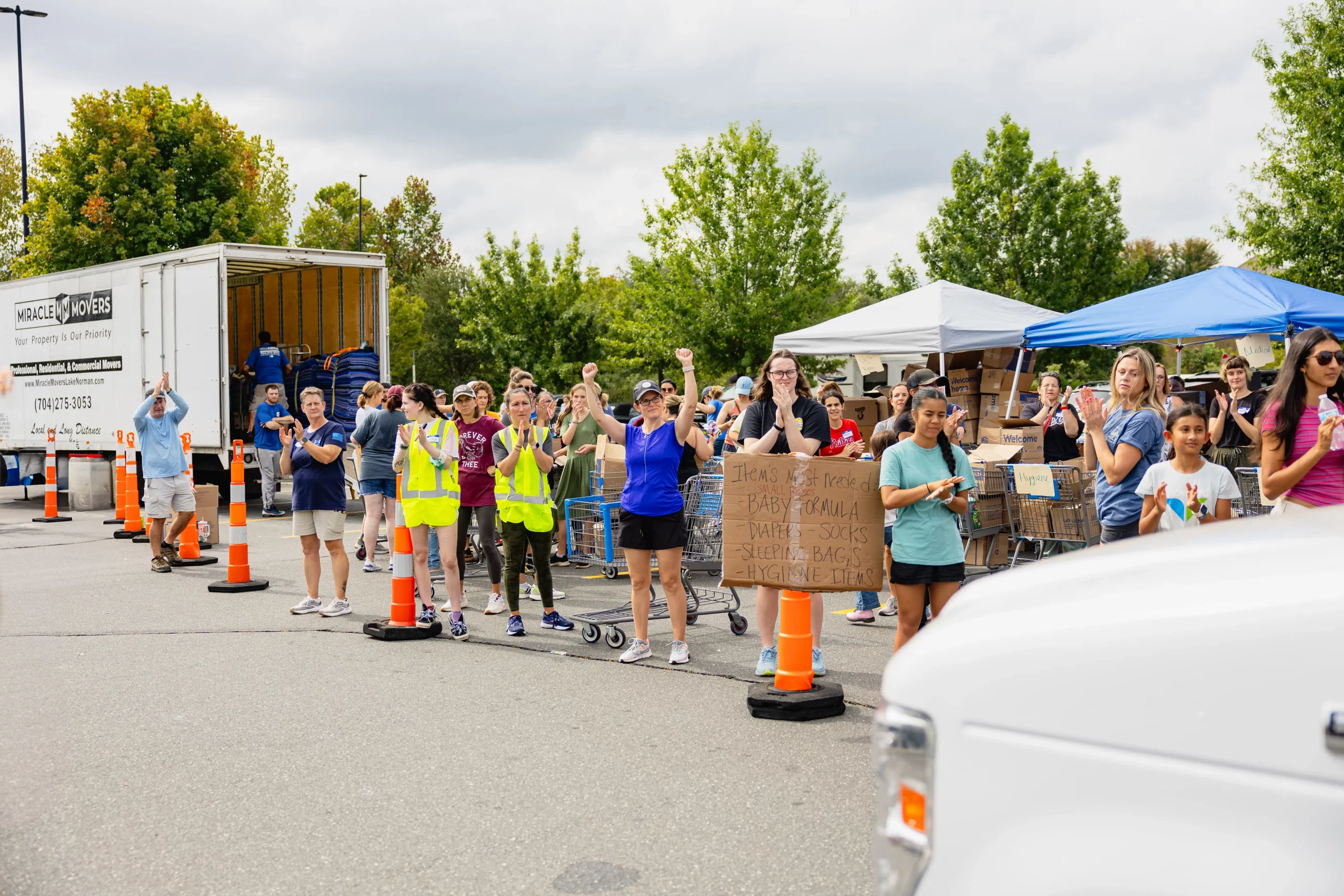 Vendors and guests at outdoor community fundraising event for the damage cause by Hurricane Helene.