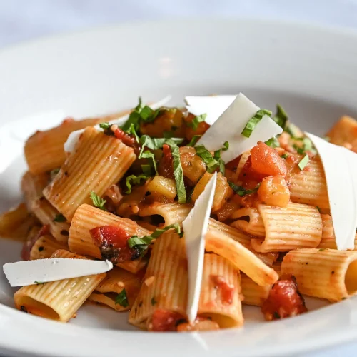 Fresh pasta garnished with basil and parmesan captured for a restaurant marketing campaign.