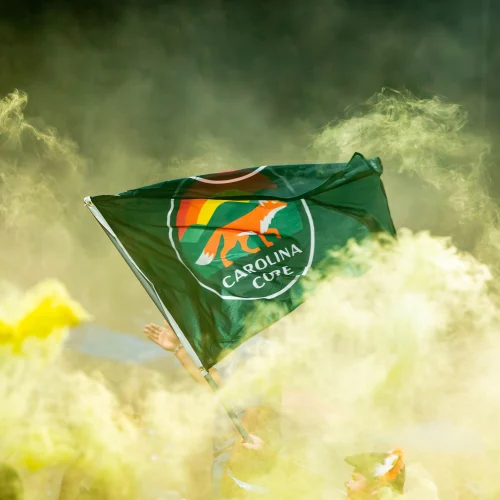 Flag waving in smoke during sports hype video production in High Point, NC by MJS Live Productions.