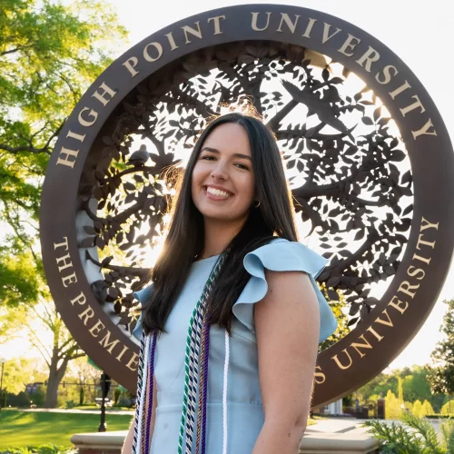 High Point University graduate portrait at campus landmark.