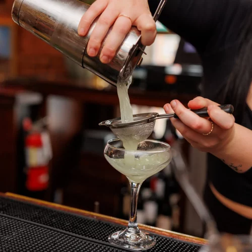 MJS Live Productions capturing a bartender pulling a perfect martini shot during a café brand photoshoot.