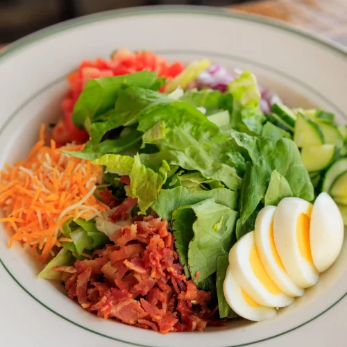 Healthy salad bowl with eggs, greens, and beets photographed for menu design by MJS Live Productions.