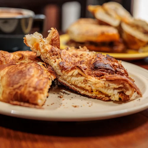 Breakfast sandwich spread and coffee setup captured for café social media.