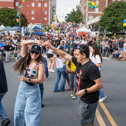 Street photography capturing festival attendees downtown at the Hispanic League Fiesta.