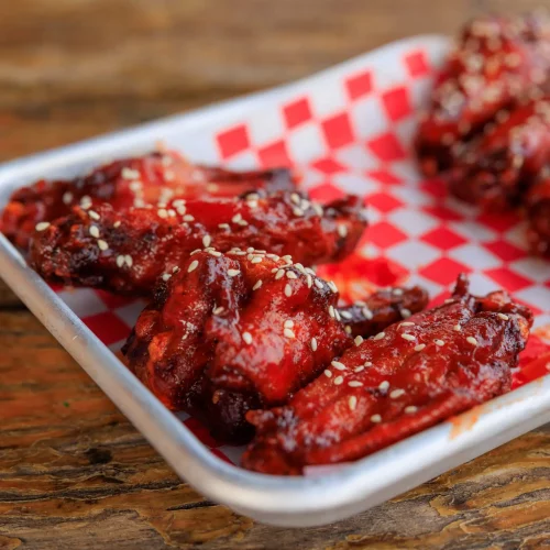 Close-up of saucy chicken wings styled for food photography content.