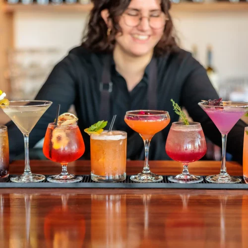 Vibrant row of cocktails displayed for mixology photography.
