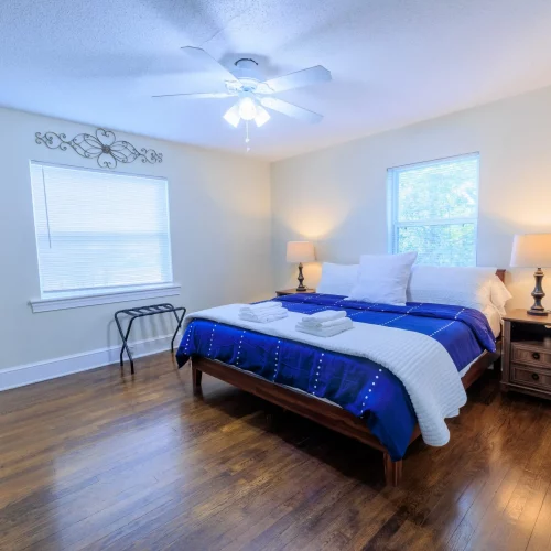 Bedroom with hardwood floors photographed for interior design portfolio.
