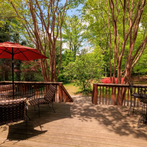 Outdoor patio dining area surrounded by greenery at a local restaurant.