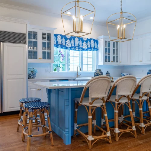 Coastal kitchen design with white cabinets and blue accents.