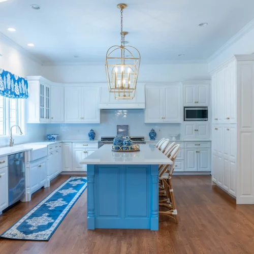 Bright farmhouse kitchen with bar seating and hardwood floors.