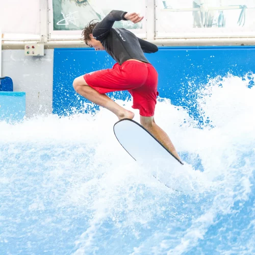 Action photo of surfer performing aerial trick in Outer Banks, North Carolina, captured by MJS Live Productions.