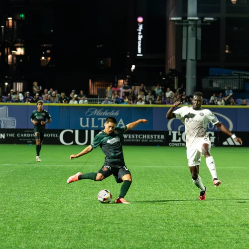 Soccer players competing during live match photography by MJS Live Productions.
