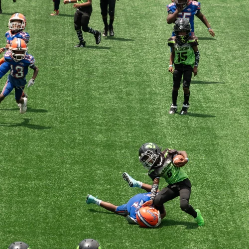 Athletes competing during youth football camp coverage by MJS Live Productions.