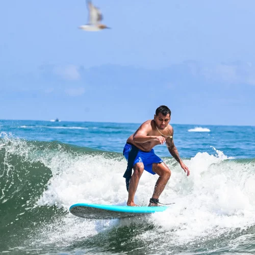 Surfer catching wave during beach sports coverage in Outer Banks, North Carolina. by MJS Live Productions.