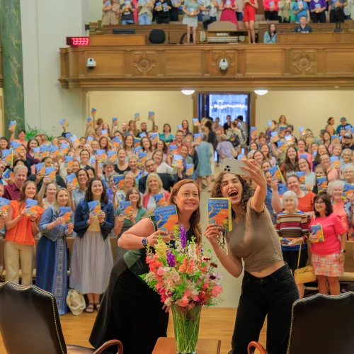 MJS Live Productions capturing a selfie between a famous author and a crowded event