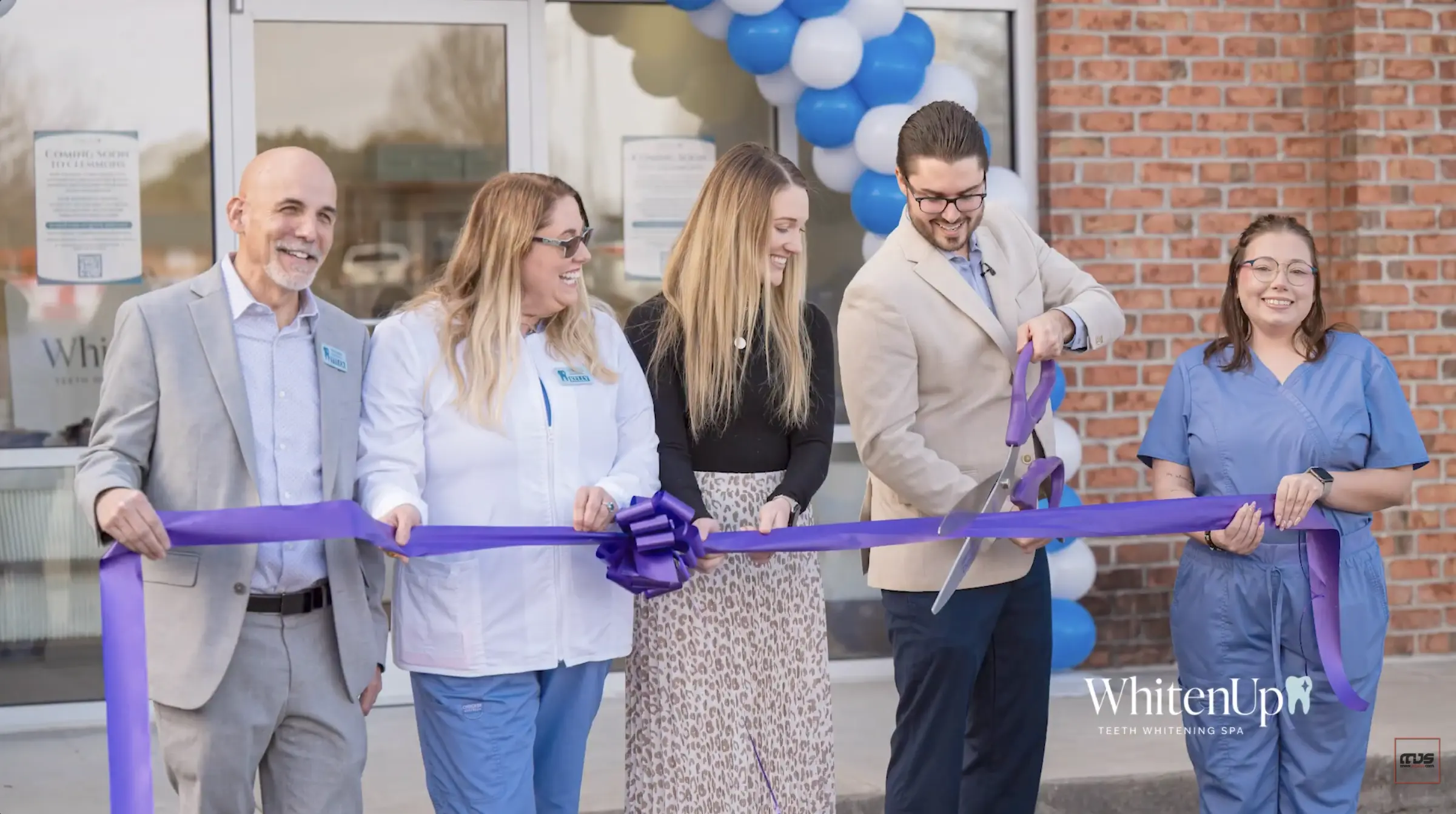 Event photography of ribbon cutting ceremony in Lewisville-Clemmons capturing business grand opening moment