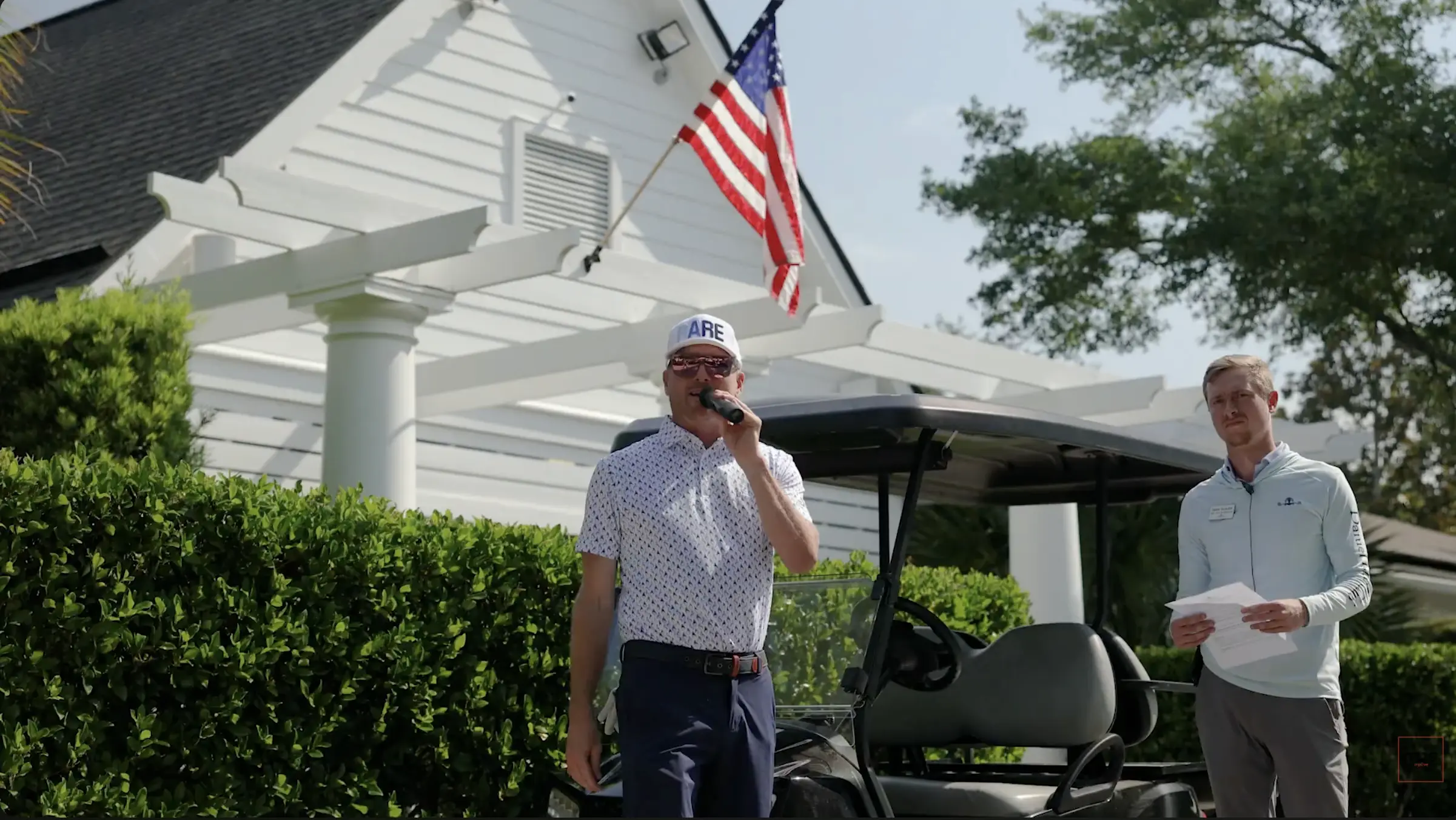 Event photography capturing speaker addressing guests at outdoor corporate event in North Carolina